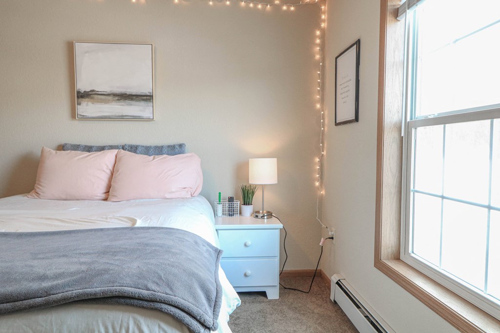 a bedroom with a bed and a night stand and a window at Boulder Ridge, Minnesota, 55811