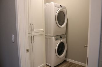A white washing machine and dryer in a small laundry room.