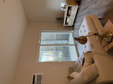 A living room with a couch and a window.