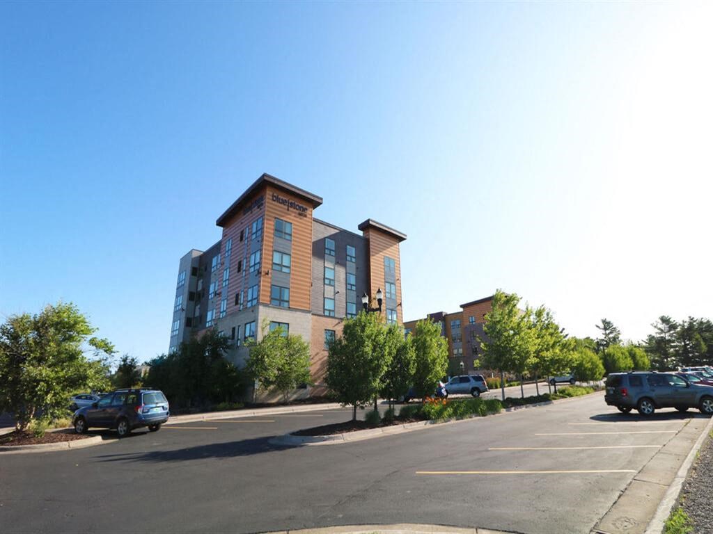 an empty parking lot in front of an apartment building at Bluestone Lofts, Minnesota