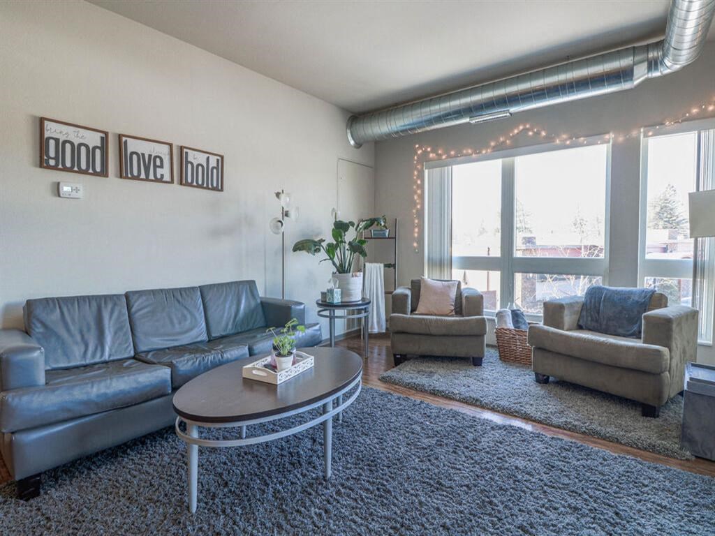 a living room with couches and chairs and a coffee table at Bluestone Lofts, Duluth, MN