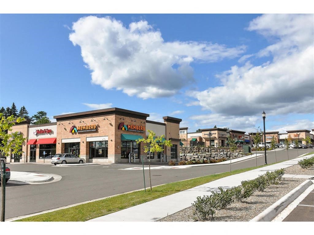 a shopping center with stores and a parking lot at Bluestone Lofts, Minnesota, 55803