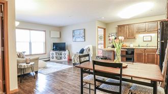 a living room and kitchen with a wooden table at Boulder Ridge, Duluth, MN 55811