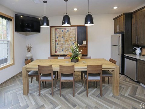 a dining room with a wooden table and chairs at Arbor Ridge, Forest Lake, MN