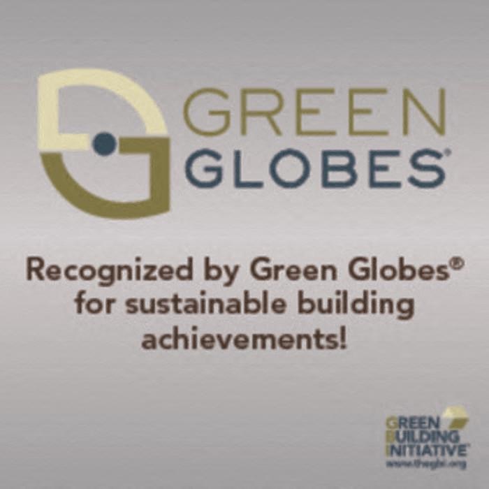 the logo of green globes is displayed on a white wall at Arbor Ridge, Forest Lake, Minnesota
