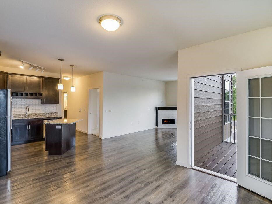 a living room and kitchen with a sliding glass door at Arbor Ridge, Forest Lake, Minnesota