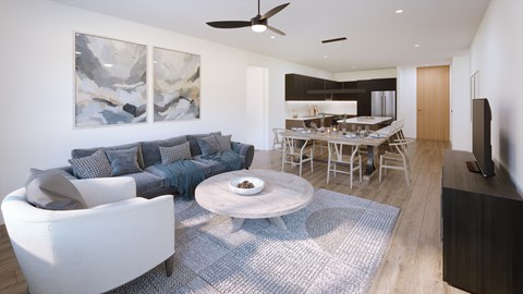 A modern living room with a white sofa and a grey rug.