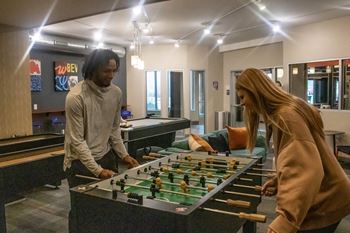 a man and a woman playing a game of foosball at Bluestone Lofts, Minnesota