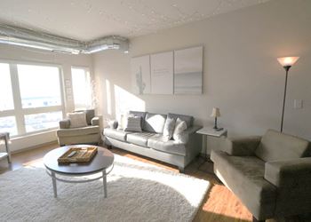 a living room with a couch and a coffee table at Bluestone Lofts, Duluth, MN