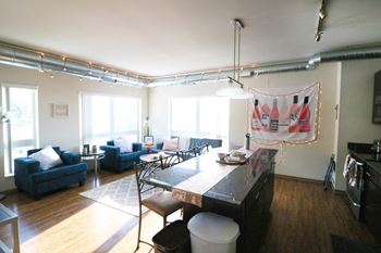 a dining room and living room with a table and chairs at Bluestone Lofts, Minnesota