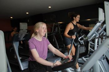 two women on exercise machines at the gym at Bluestone Lofts, Duluth Minnesota