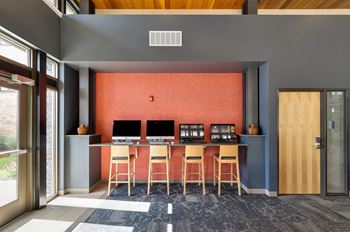 a room with a desk with three monitors and three chairs at Bluestone Lofts, Minnesota
