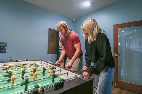 a man and a woman playing foosball on a table at Summit Ridge, Minnesota, 55811
