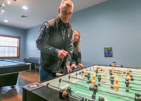 two people playing a game of foosball at a table at Summit Ridge, Duluth, MN