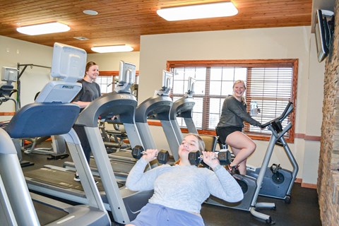 three women on exercise machines in a gym at Summit Ridge, Duluth, Minnesota