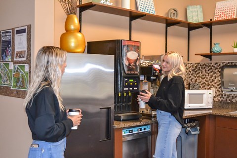 two women standing in a kitchen drinking coffee at Summit Ridge, Duluth, MN
