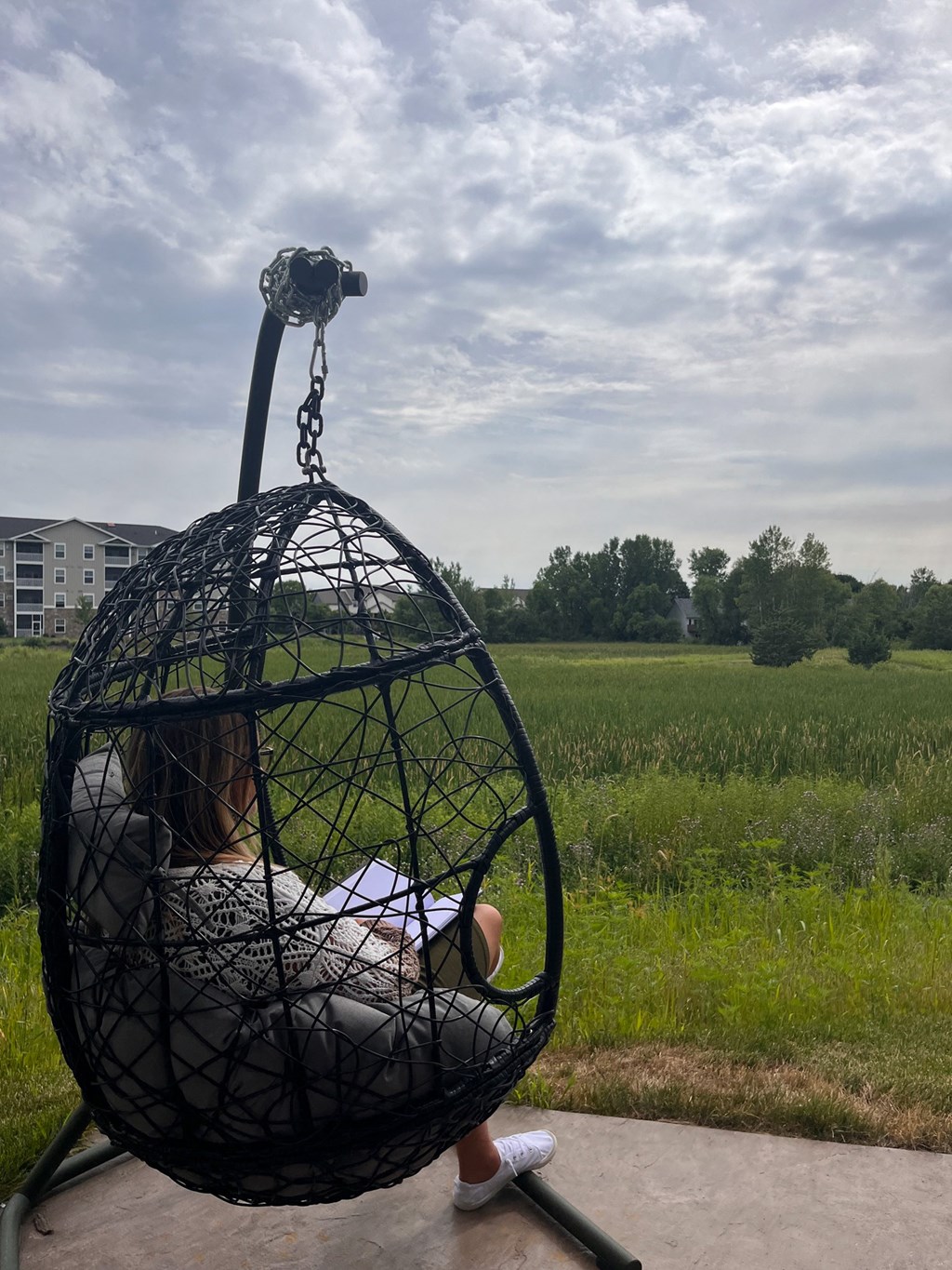 a child is sitting in a bird cage on a swing  at Timber Ridge, Forest Lake, MN, 55025