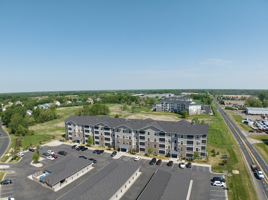 an aerial view of a city street with buildings and trees  at Timber Ridge, Minnesota, 55025