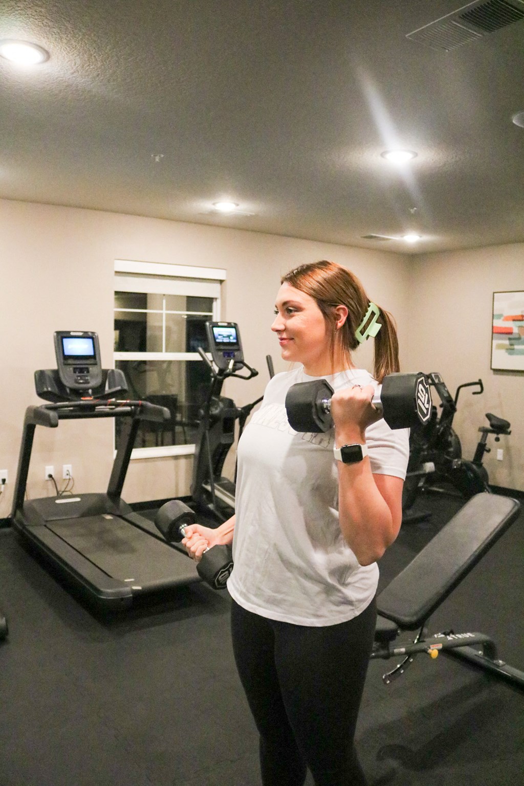 a woman doing a dumbbell workout in a gym  at Timber Ridge, Forest Lake, MN