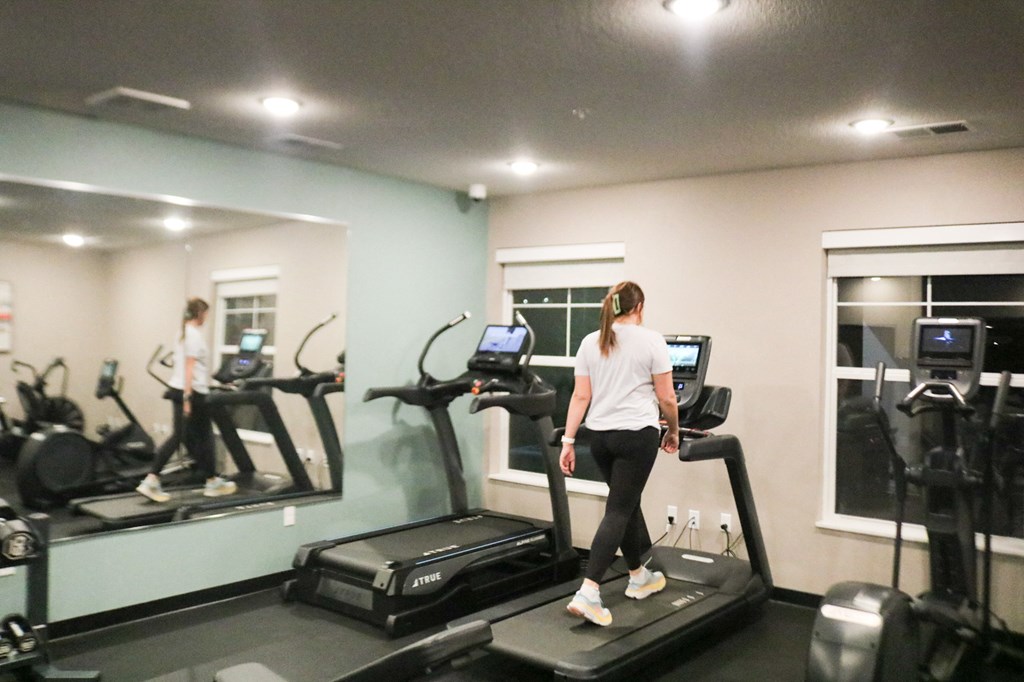a woman running on a treadmill in a gym  at Timber Ridge, Forest Lake, MN, 55025