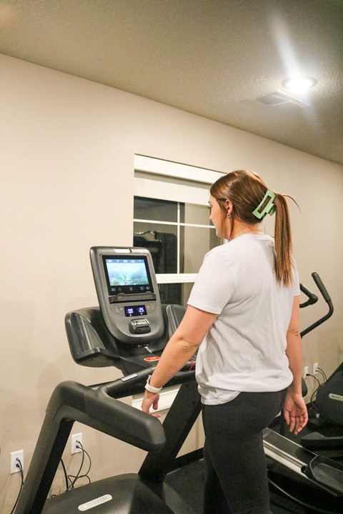 a woman running on a treadmill at the gym  at Timber Ridge, Minnesota