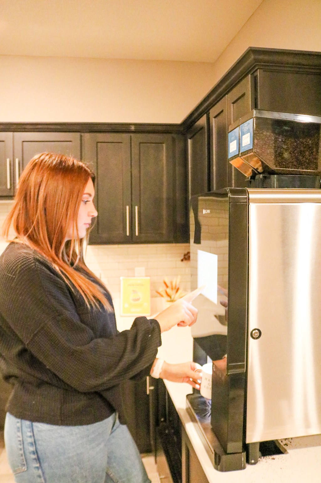 a woman standing in a kitchen putting food into a refrigerator  at Timber Ridge, Minnesota, 55025