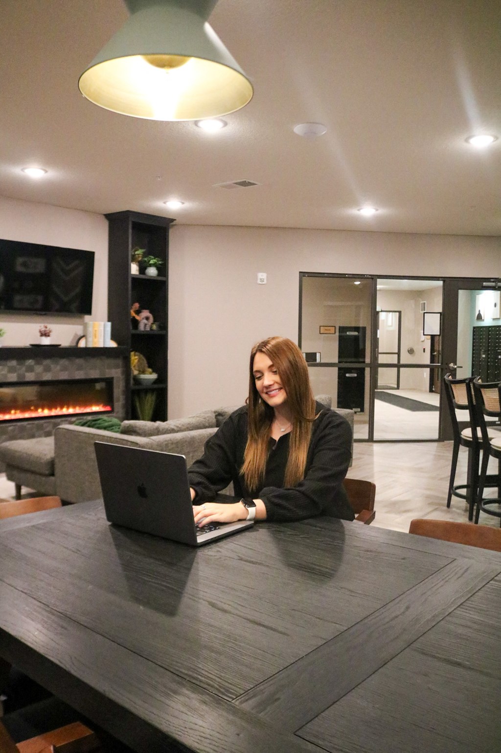 a woman sitting at a table with a laptop computer  at Timber Ridge, Minnesota, 55025
