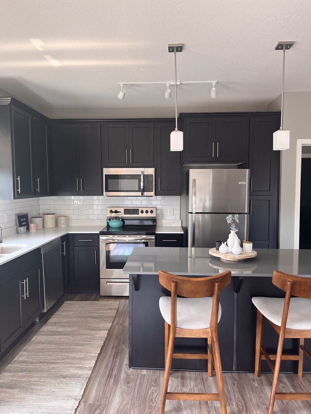 a kitchen with black cabinets and stainless steel appliances  at Timber Ridge, Minnesota