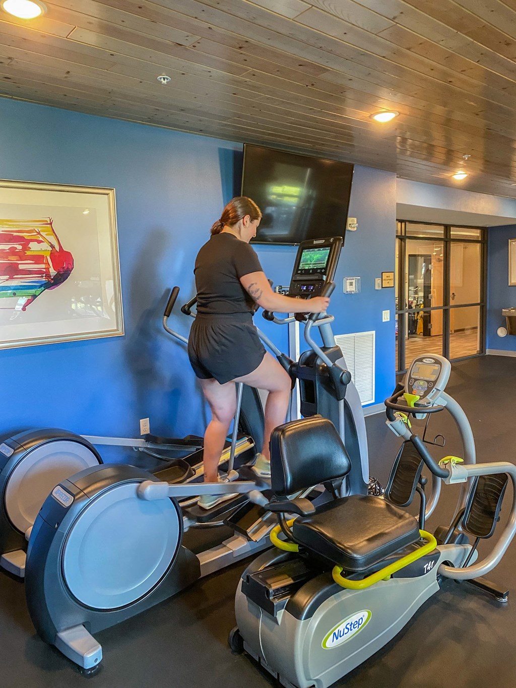 a woman running on a treadmill in a gym  at Timber Ridge, Minnesota