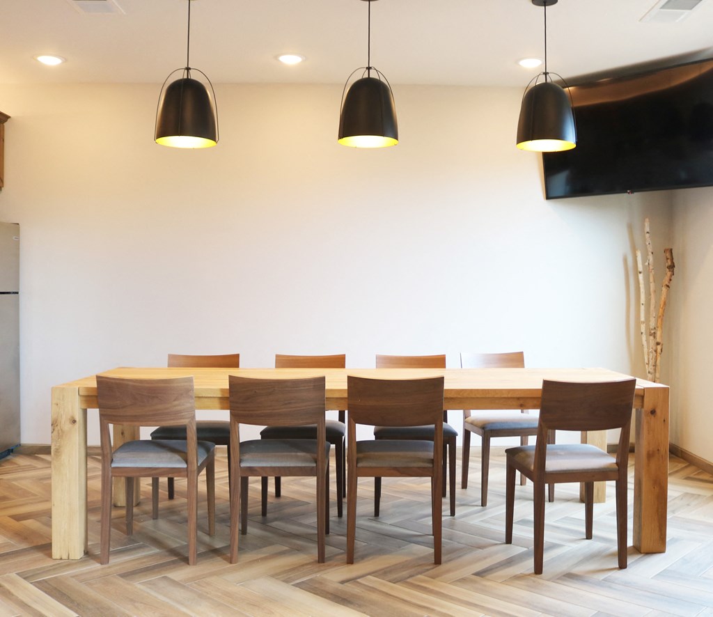 a dining room with a wooden table and chairs  at Timber Ridge, Forest Lake