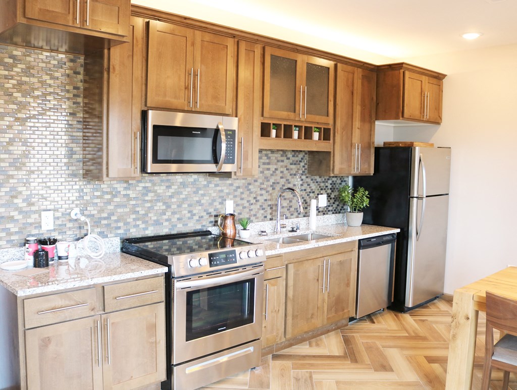 a kitchen with wooden cabinets and stainless steel appliances  at Timber Ridge, Minnesota, 55025