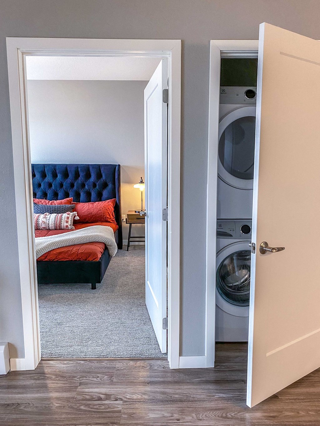 a bedroom with a bed and a washer and dryer in it  at Timber Ridge, Forest Lake