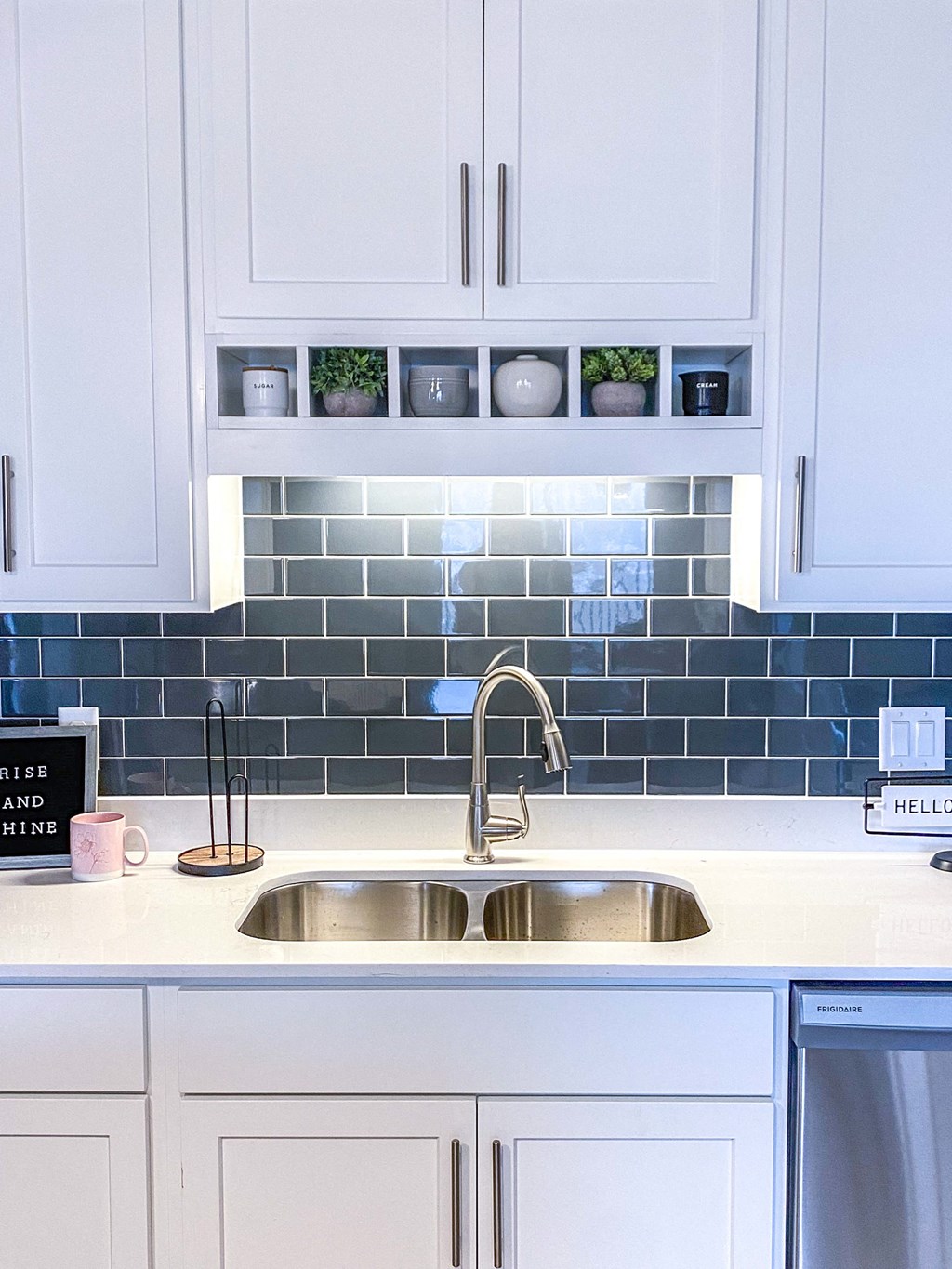 a kitchen sink with white cabinets and blue tile  at Timber Ridge, Forest Lake, MN, 55025