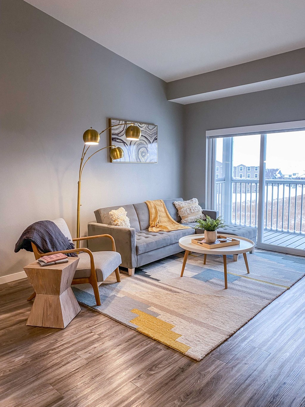 a living room with a couch and a large window  at Timber Ridge, Forest Lake, MN, 55025