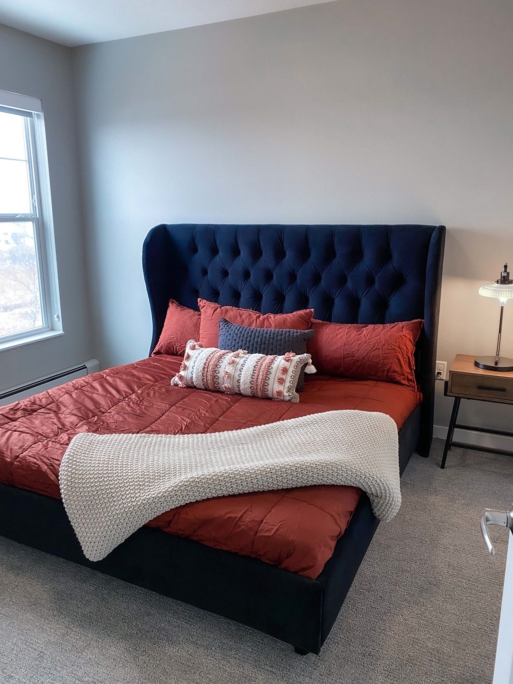 a bedroom with a bed with red sheets and pillows  at Timber Ridge, Minnesota