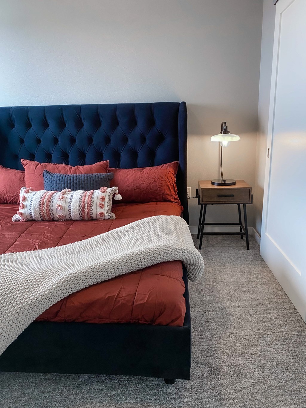 a bedroom with a bed and a nightstand with a lamp  at Timber Ridge, Forest Lake, MN, 55025