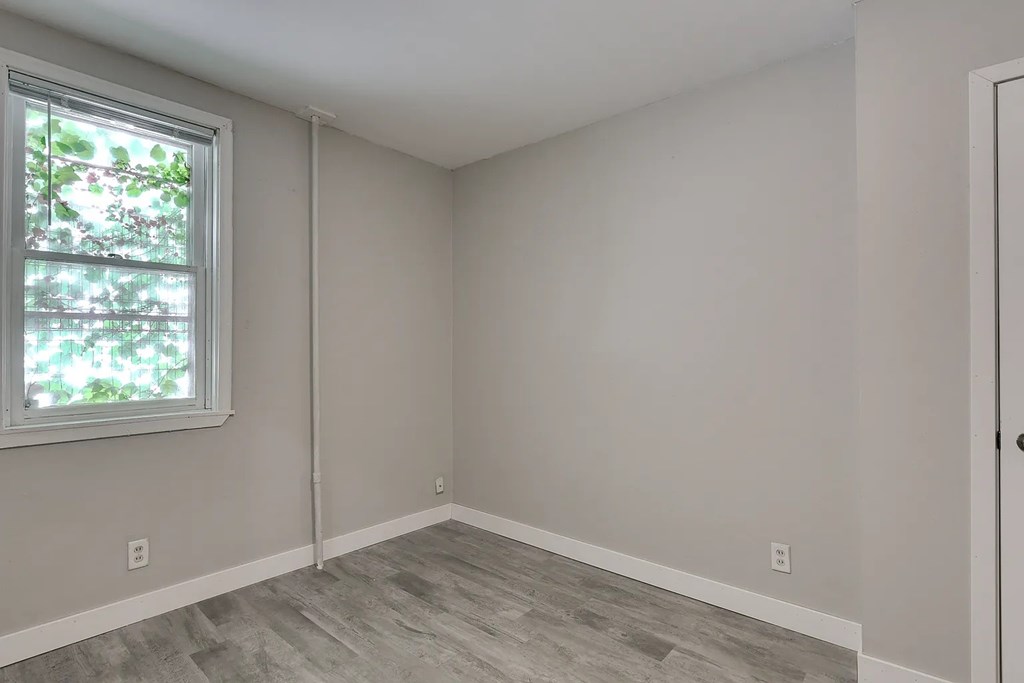 A room with a window and a door.