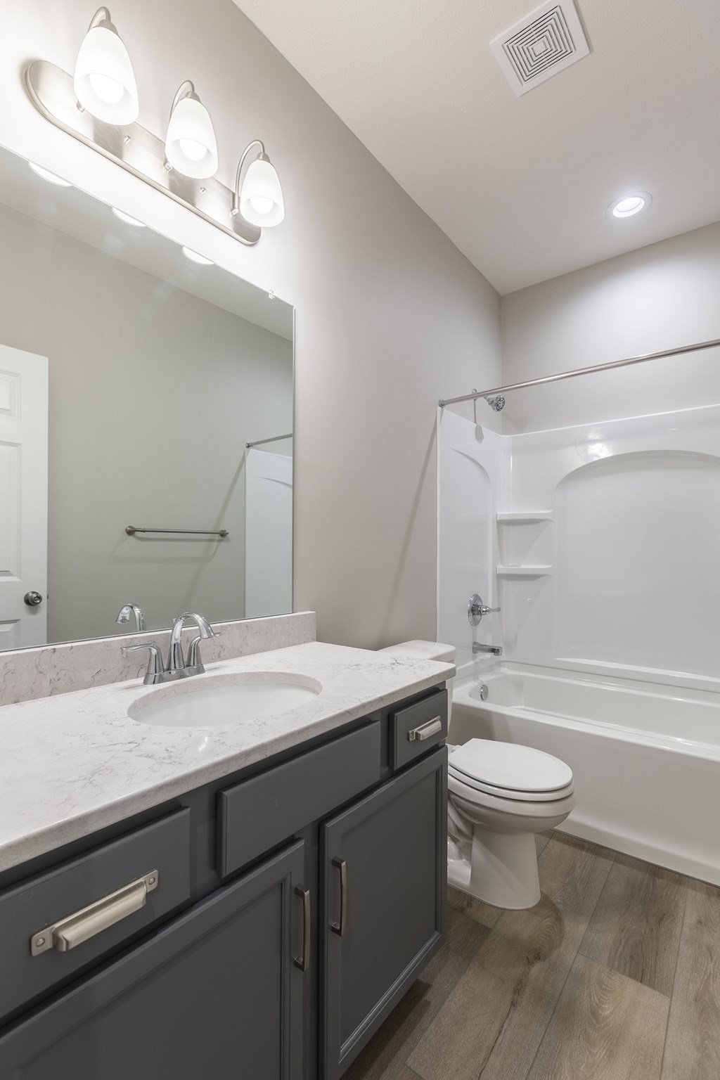 A bathroom with a sink, toilet, and bathtub.