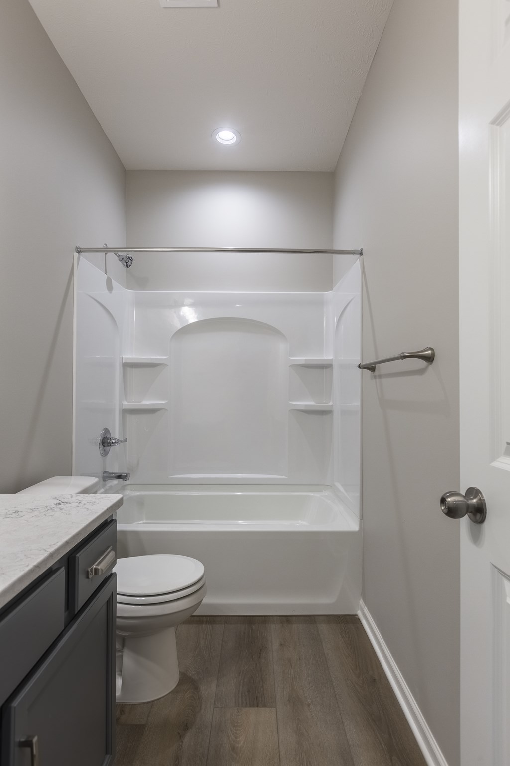 A white bathroom with a toilet, sink, and bathtub.