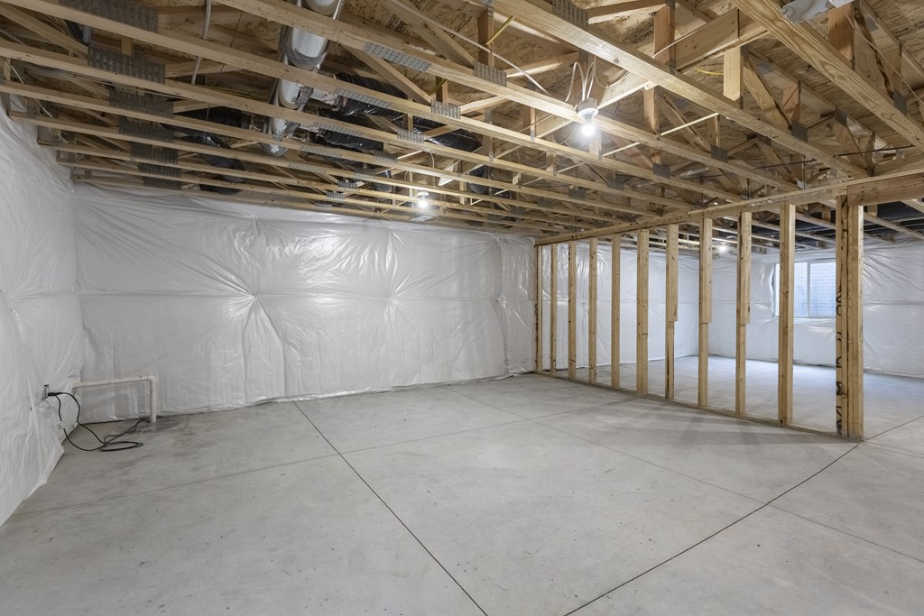 A room under construction with wooden beams and insulation on the walls.