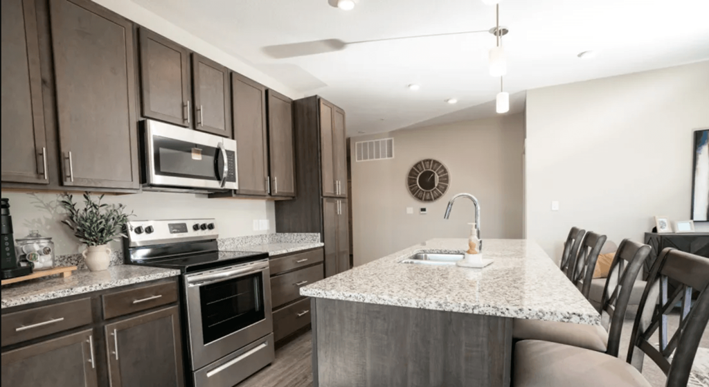 A kitchen with brown cabinets and a white countertop.