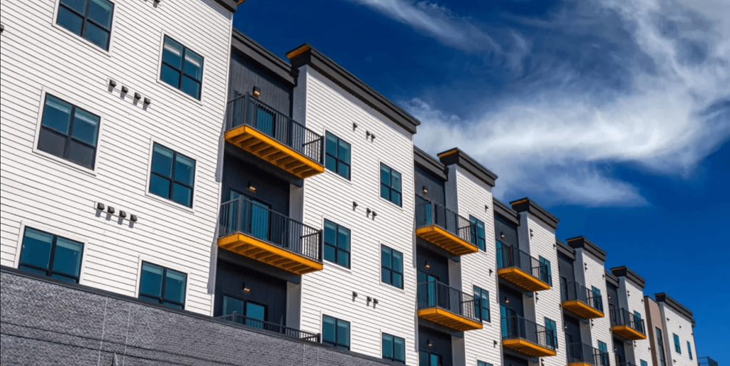 A row of modern apartment buildings with balconies.