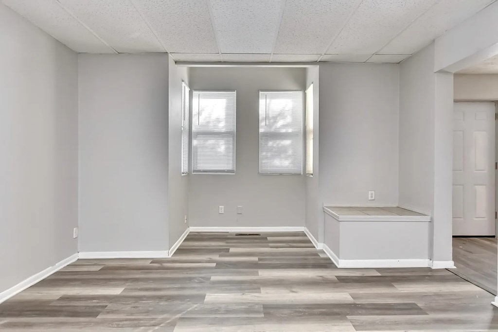 A room with a large window and a tiled floor.