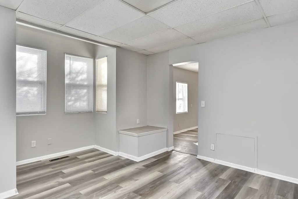A room with a wooden floor and white walls.