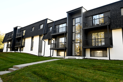 A black and white building with balconies and windows.