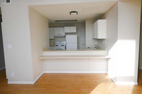 A kitchen with white cabinets and appliances.