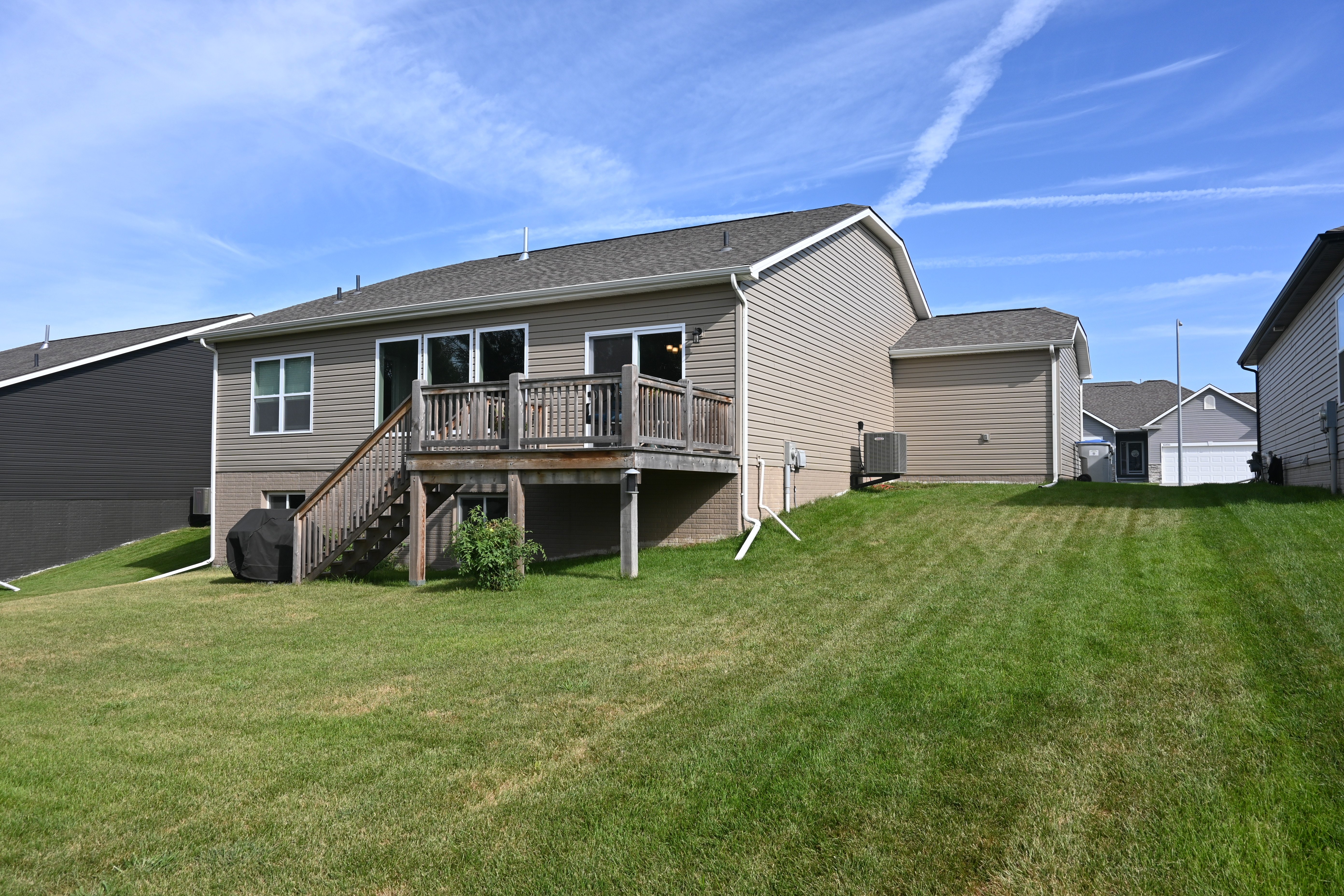 A house with a deck and a garage.