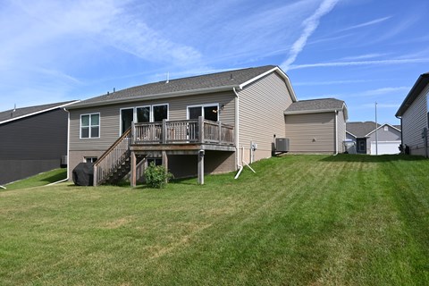 A house with a deck and a garage.