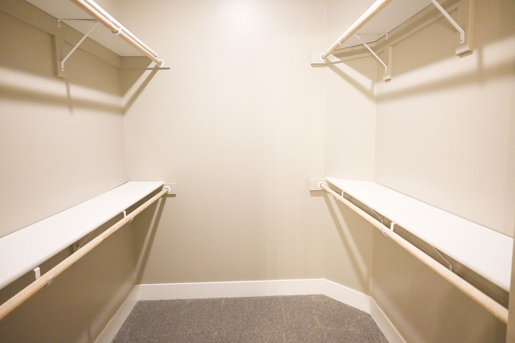 A small, empty room with a carpeted floor and white walls.