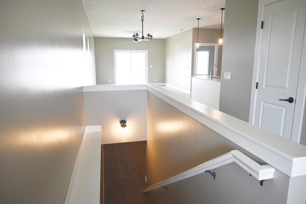 A bathroom with a large mirror and a window.